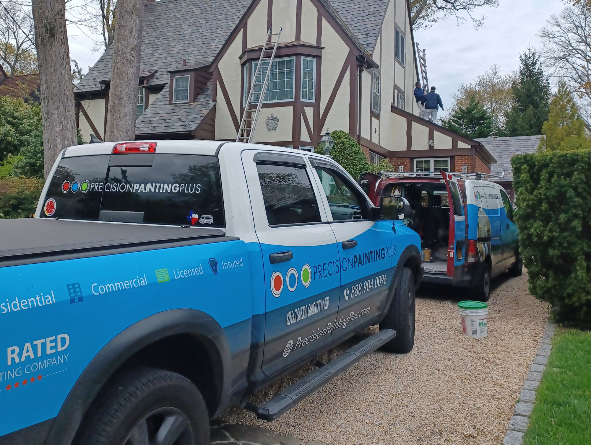Precision Painting Plus residential house exterior painting during painting team