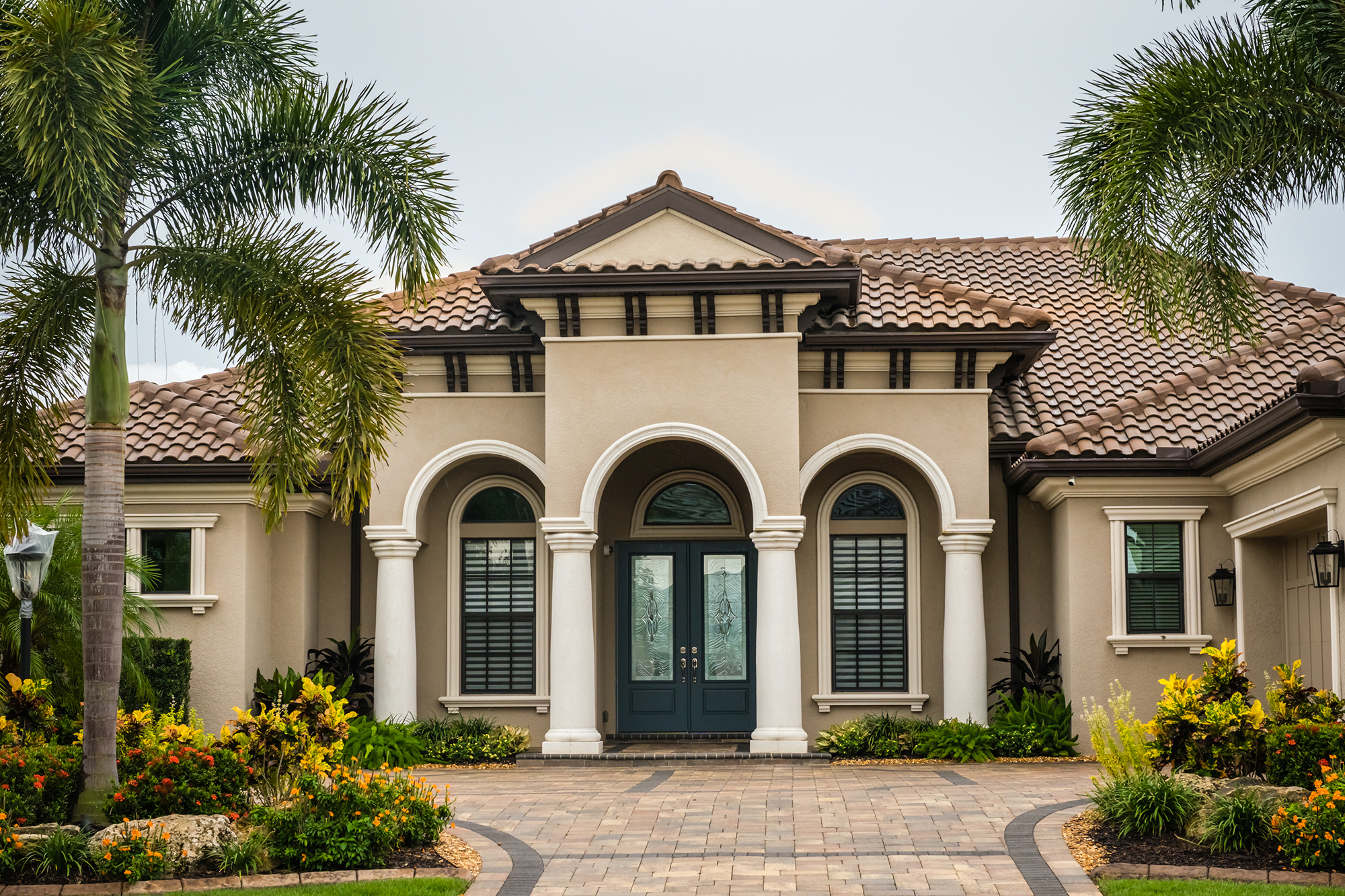 Modern house with beige painted exterior and white painted pillar entryway